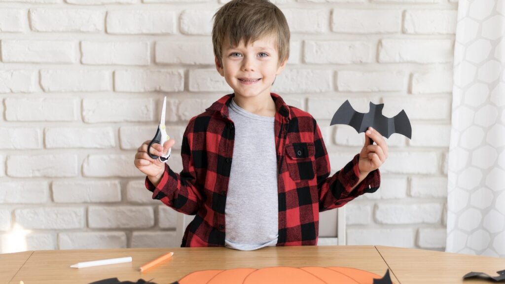 front-view-boy-with-paper-bat