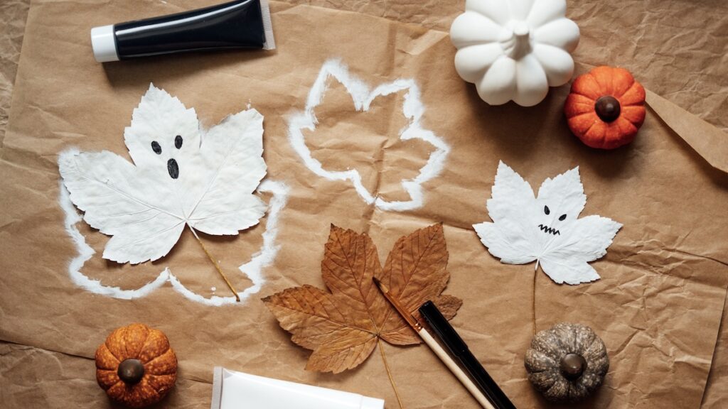 Halloween ghosts from dry maple leaves. Halloween natural DIY decor. Kids art project. Sustainable Eco-Friendly Halloween holiday decoration.