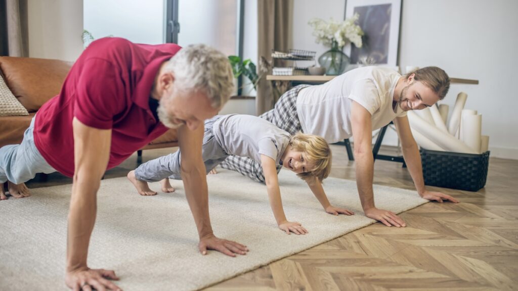 Push ups. Two men and their son doing push ups