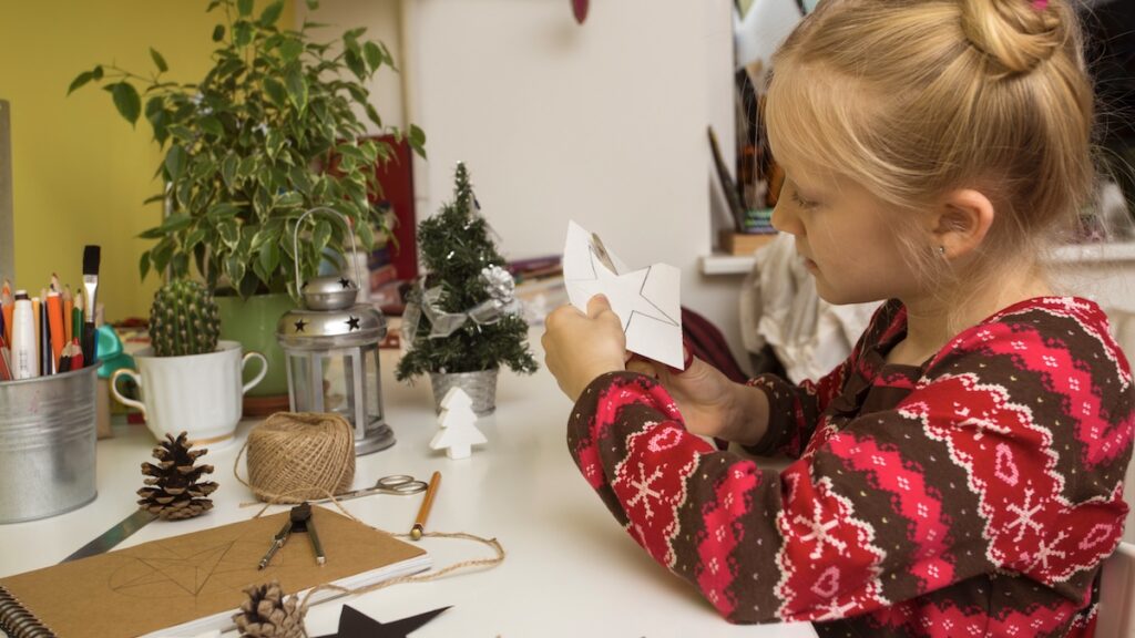Little girl creates Christmas decorations