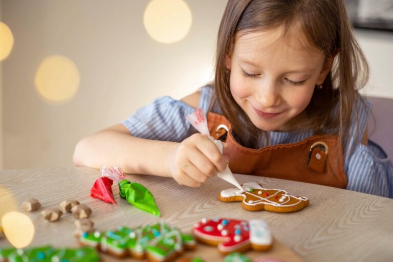 How to keep kids busy until Santa Arrives, A little girl decorates a Christmas gingerbread mitten, concept of preparations for Christmas and New Year