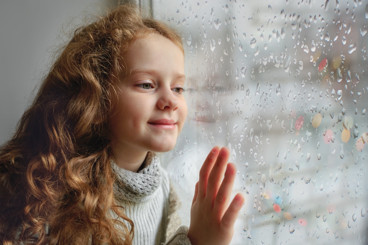 Happy child looking out the window with wet glass bad weather, Say Goodbye to Winter Blues, Creative Activities for Kids
